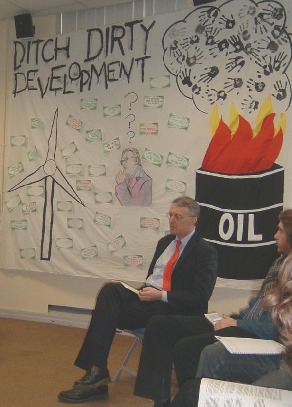 Hilary Benn (Secretary of State for International Development) with a Ditch Dirty Development banner