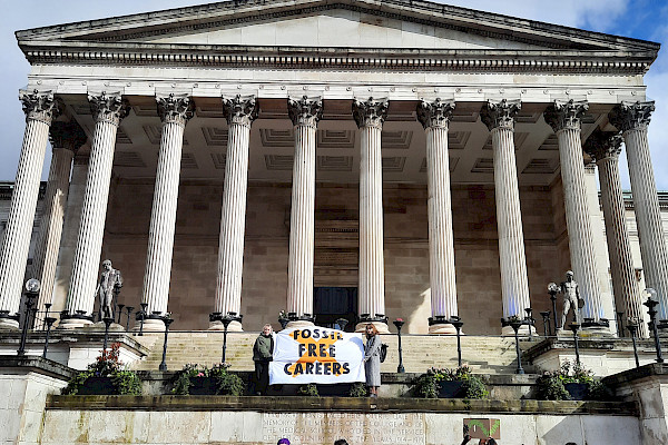 Students stand with Fossil Free Careers banner and placards outside UCL university building