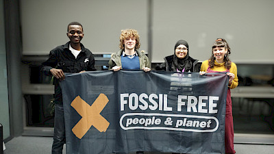 Students holding up a banner that reads Fossil Free