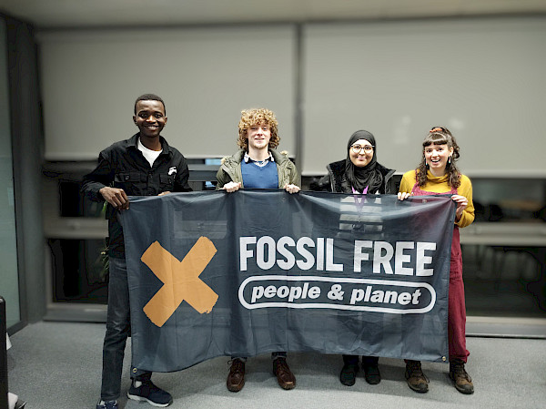 Students holding up a banner that reads Fossil Free