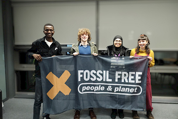 Students holding up a banner that reads Fossil Free
